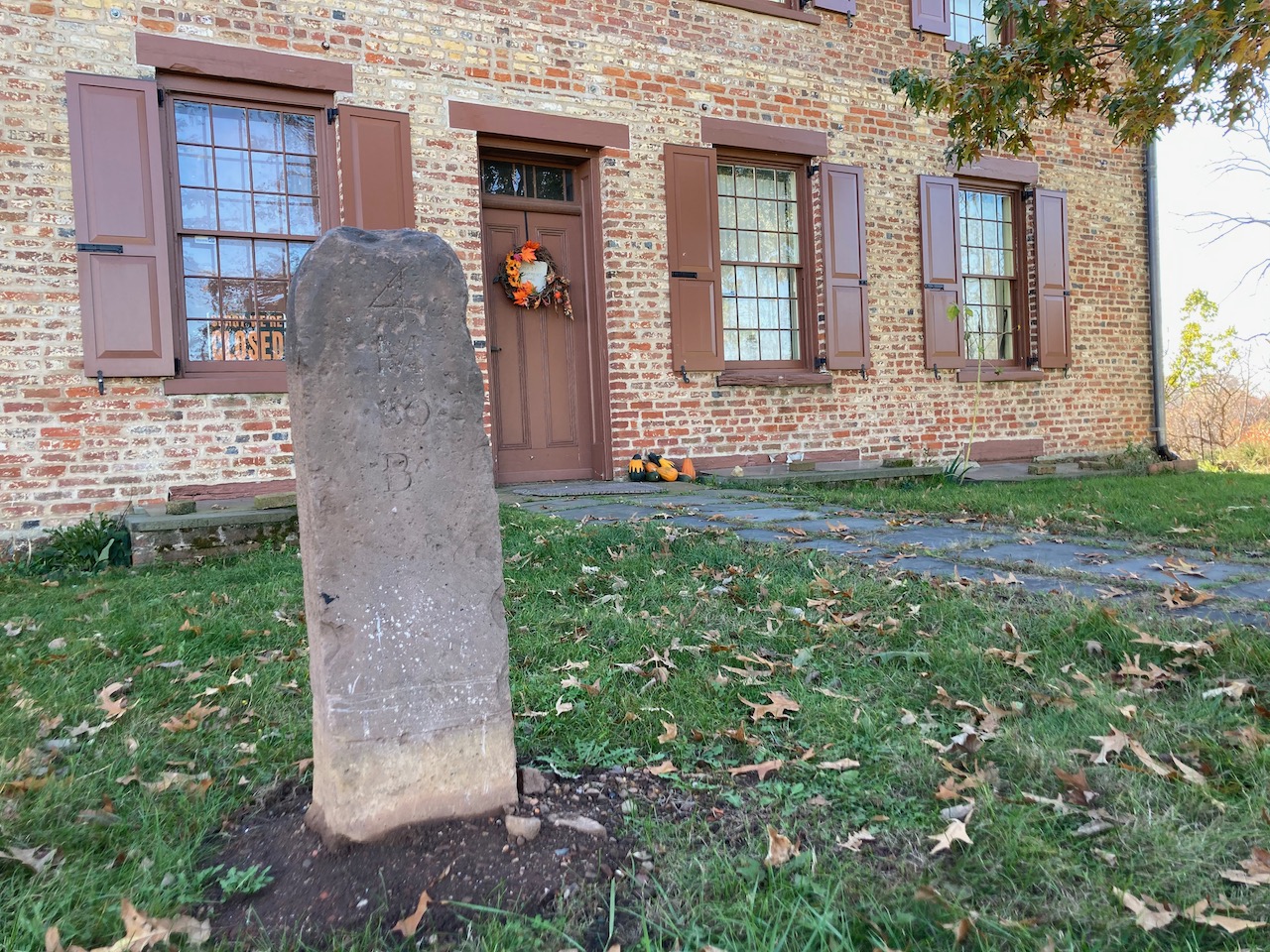 Mile marker in front of Van Veghten House.