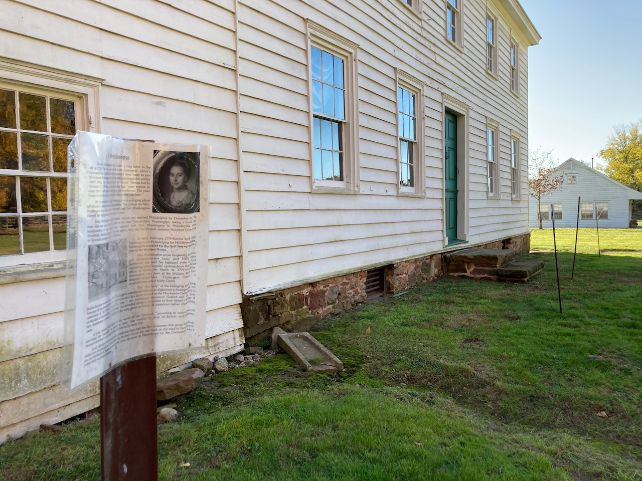 Rear of Wallace House, with small signs on sign posts around rear of house.