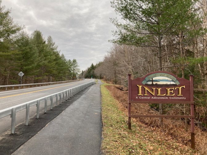 TOBIE trail beside Route 28 in Inlet. A sign by side of road says INLET A CENTRAL ADIRONDACK COMMUNITY.