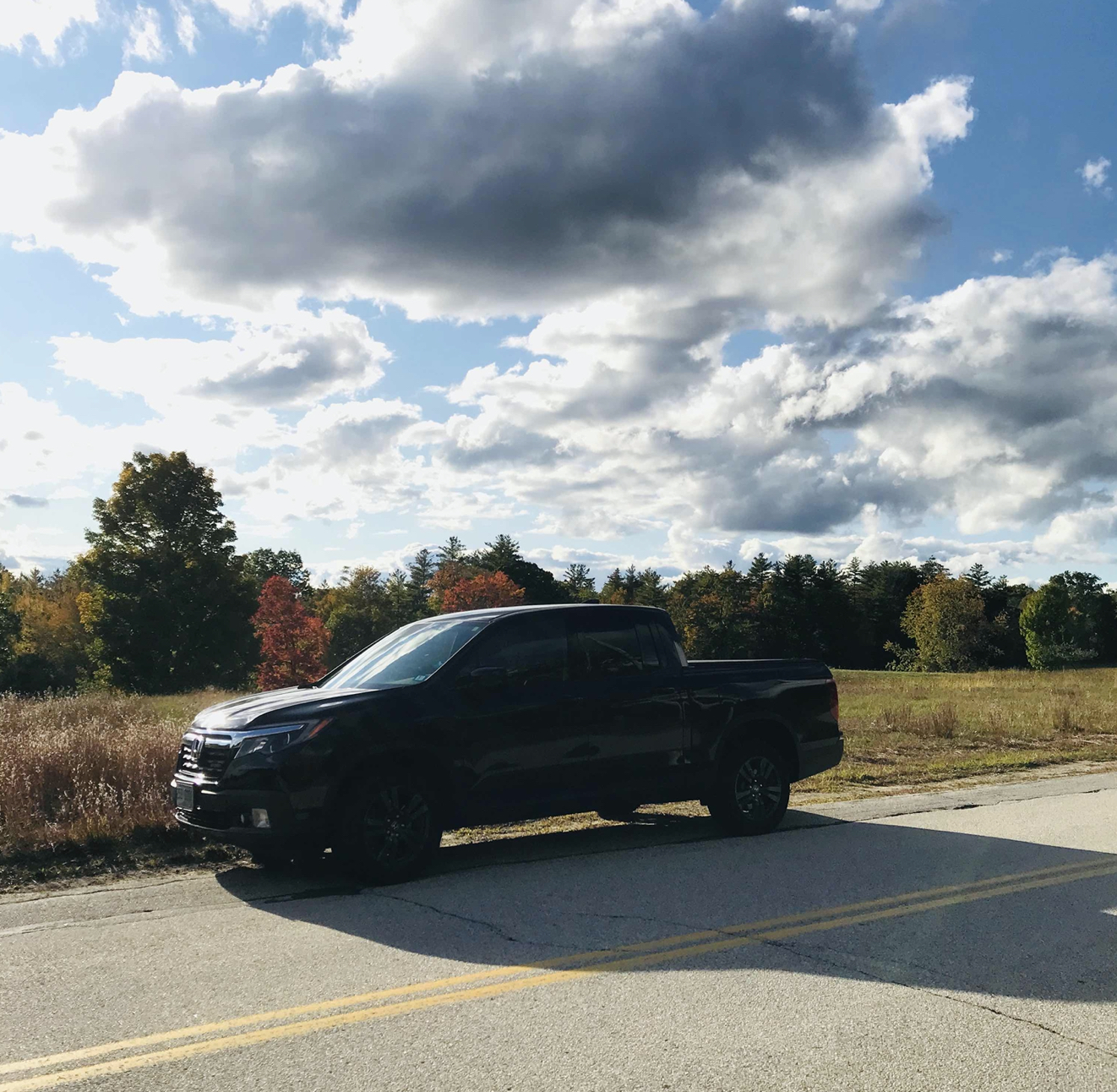 Honda Ridgeline parked on side of road.