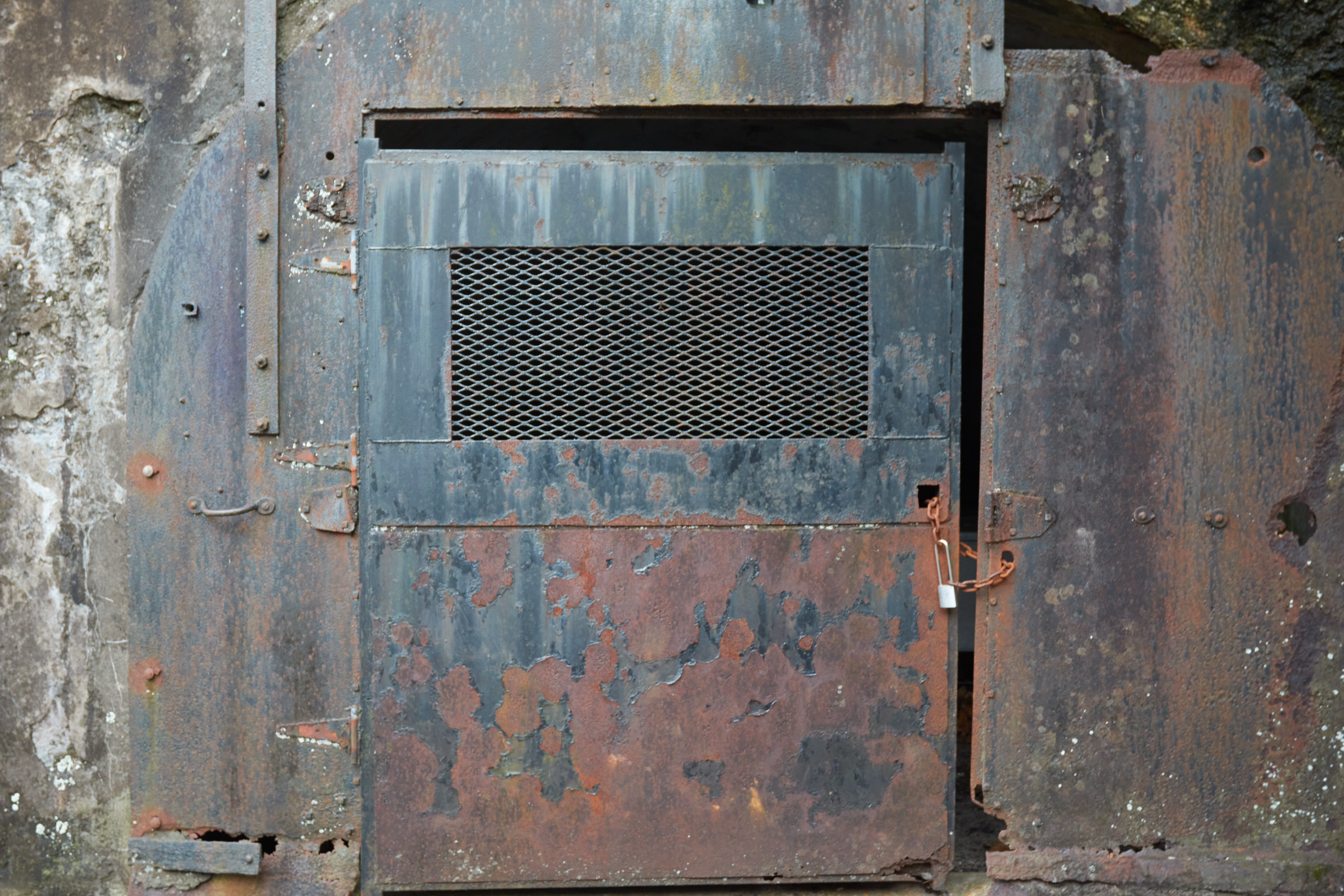 Rusting metal door in gun battery.