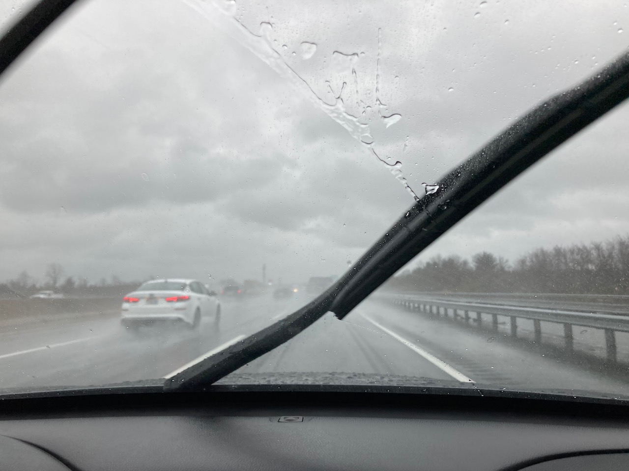 View of NJ Turnpike through rain-streaked windshield.