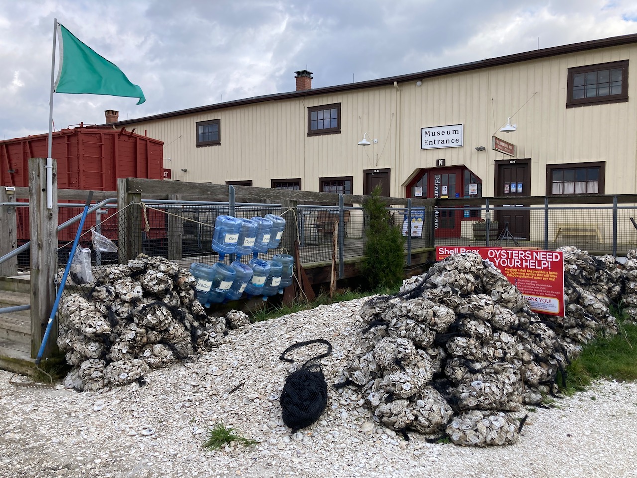 Bags of oysters beside museum entrance.