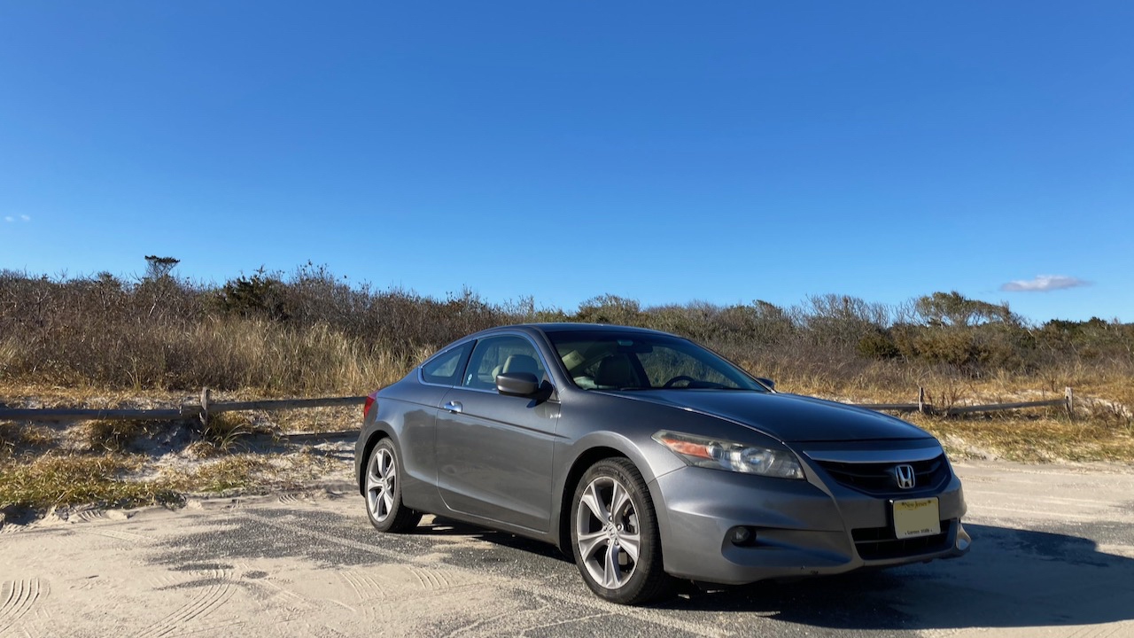 2012 Honda Accord parked in parking lot covered in sand.