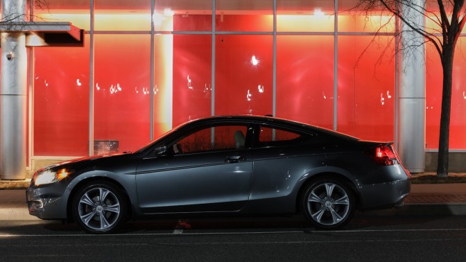 2012 Honda Accord parked in front of building with red wall.