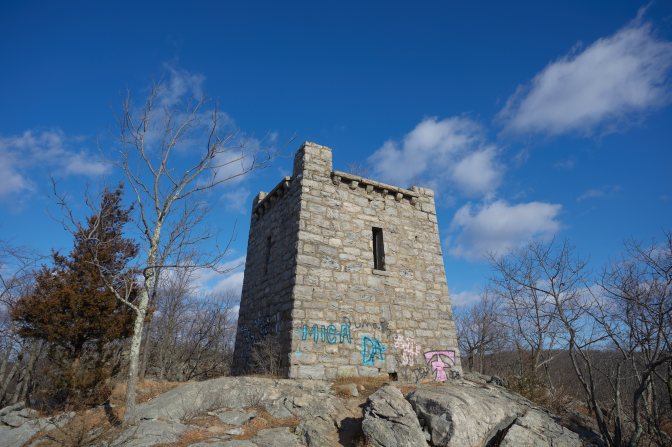 Stone tower on top of mountain.