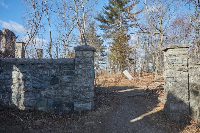 Stone gate, with one side in shadow and one in light.