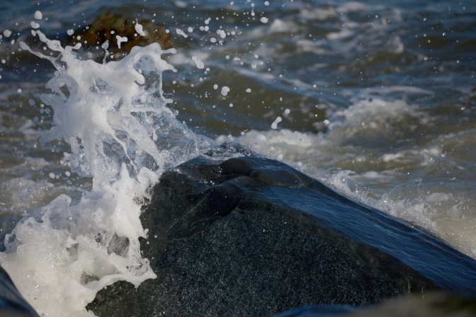 Water spraying off rock.