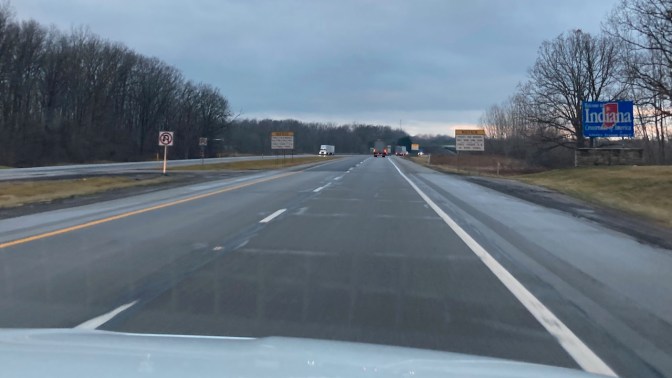 Highway I-80 with welcome sign for Indiana on side of road.