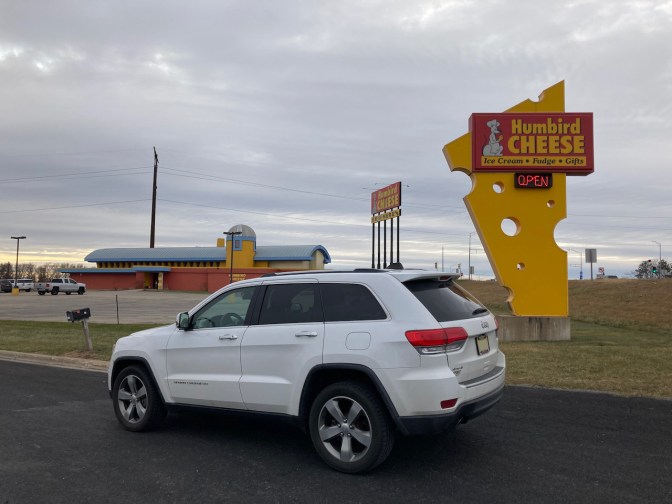 2014 Jeep Grand Cherokee, parked in front of Humbird Cheese sign.