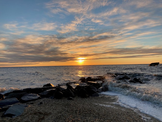 View of Sunset Beach as sun lowers in horizon.