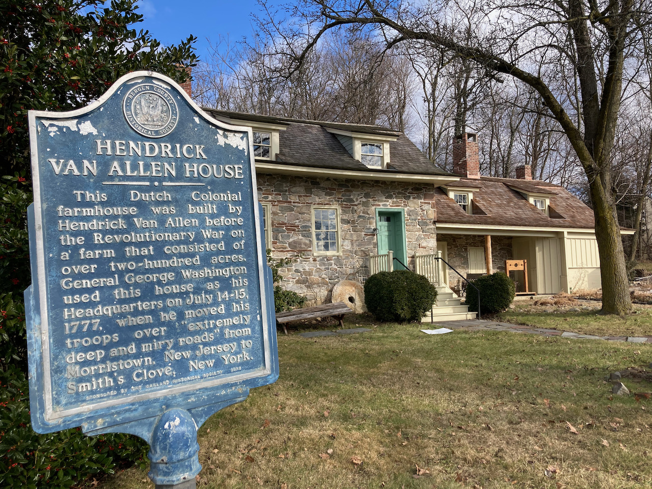 Exterior of Van Allen House, which informational sign on left of image.
