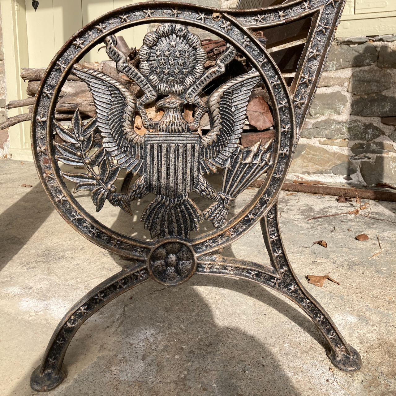 Wrought iron bench with seal of the President on the side.