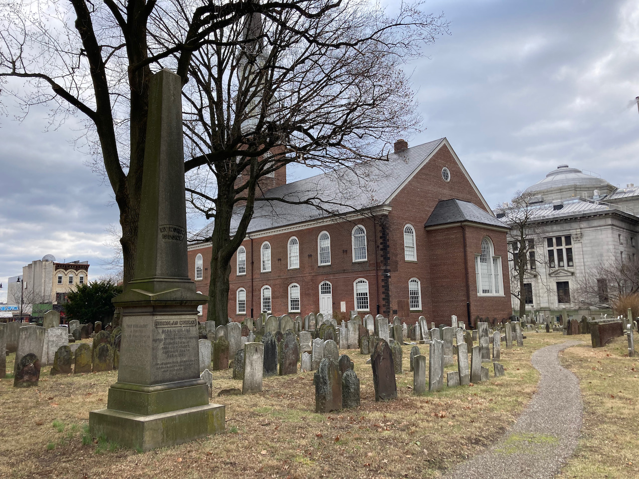 Large stone monument in cemetery.