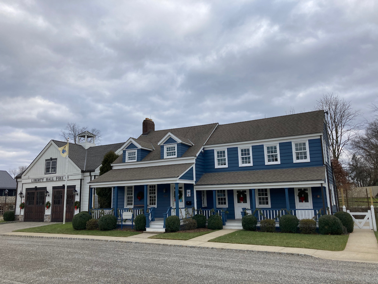 Exterior of blue two-story house, and fire station.