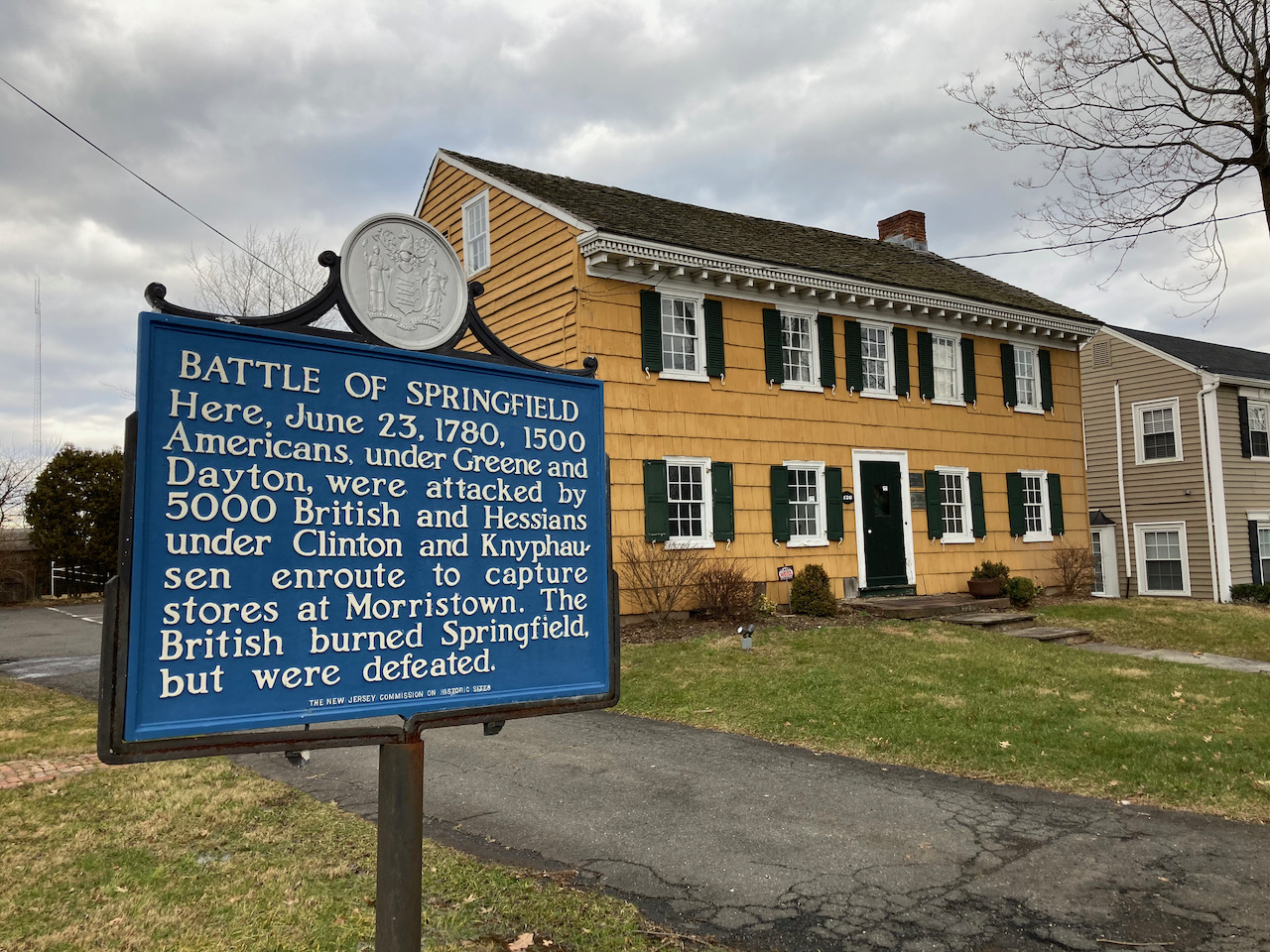 Exterior of the Osborn Cannonball House, with a sign outside that says BATTLE OF SPRINGFIELD HERE JUNE 23 1780, 1500 AMERICANS UNDER GREENE AND DAYTON WERE ATTACKED BY 5000 BRITISH AND HESSIANS UNDER CLINTON AND KNYPHAUSEN ENROUTE TO CAPTURE STORES AT MORRISTOWN. THE BRITISH BURNED SPRINGFIELD BUT WERE DEFEATED.