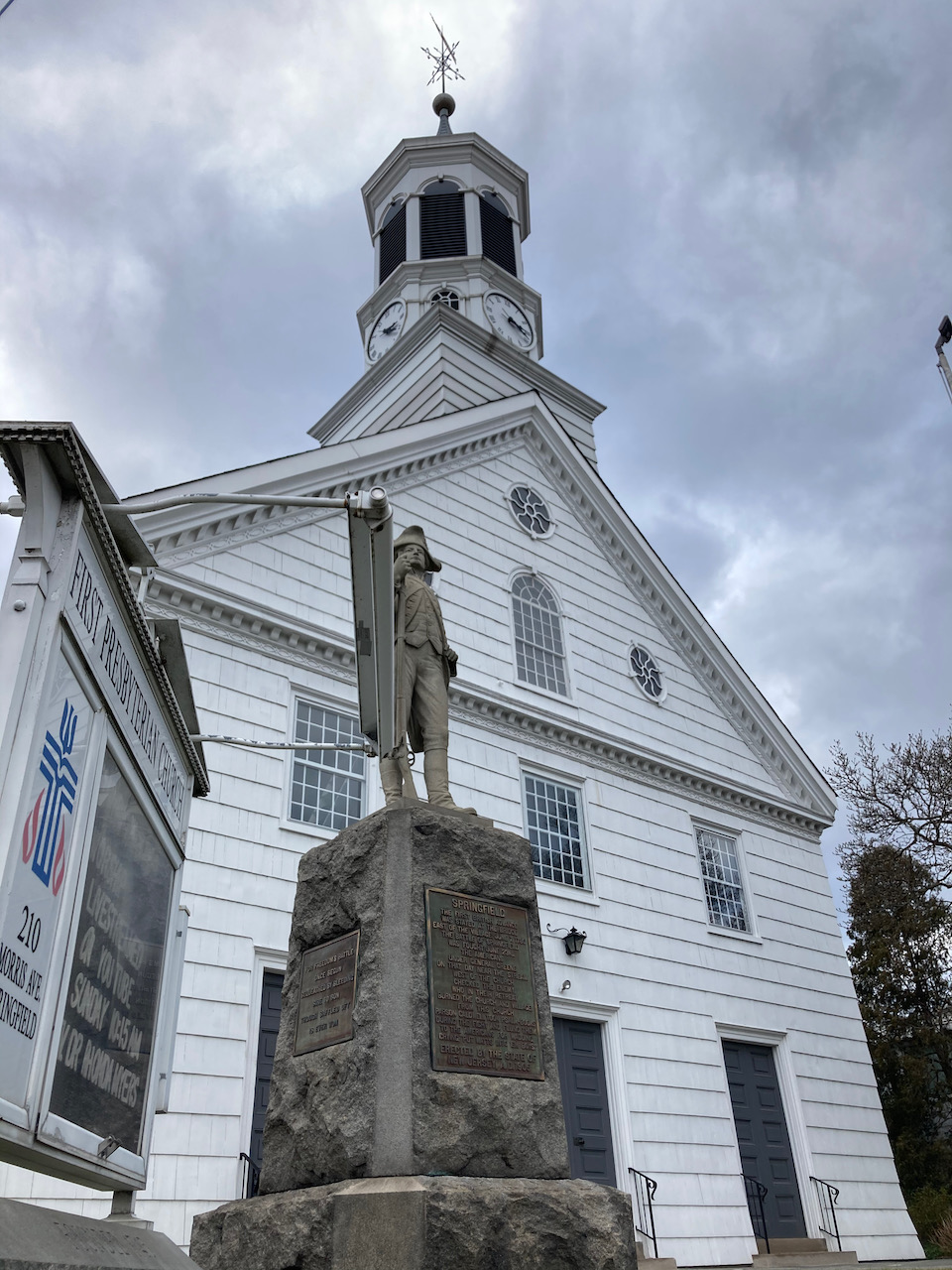 Exterior of First Presbyterian Church of Springfield, with sign and status in front.