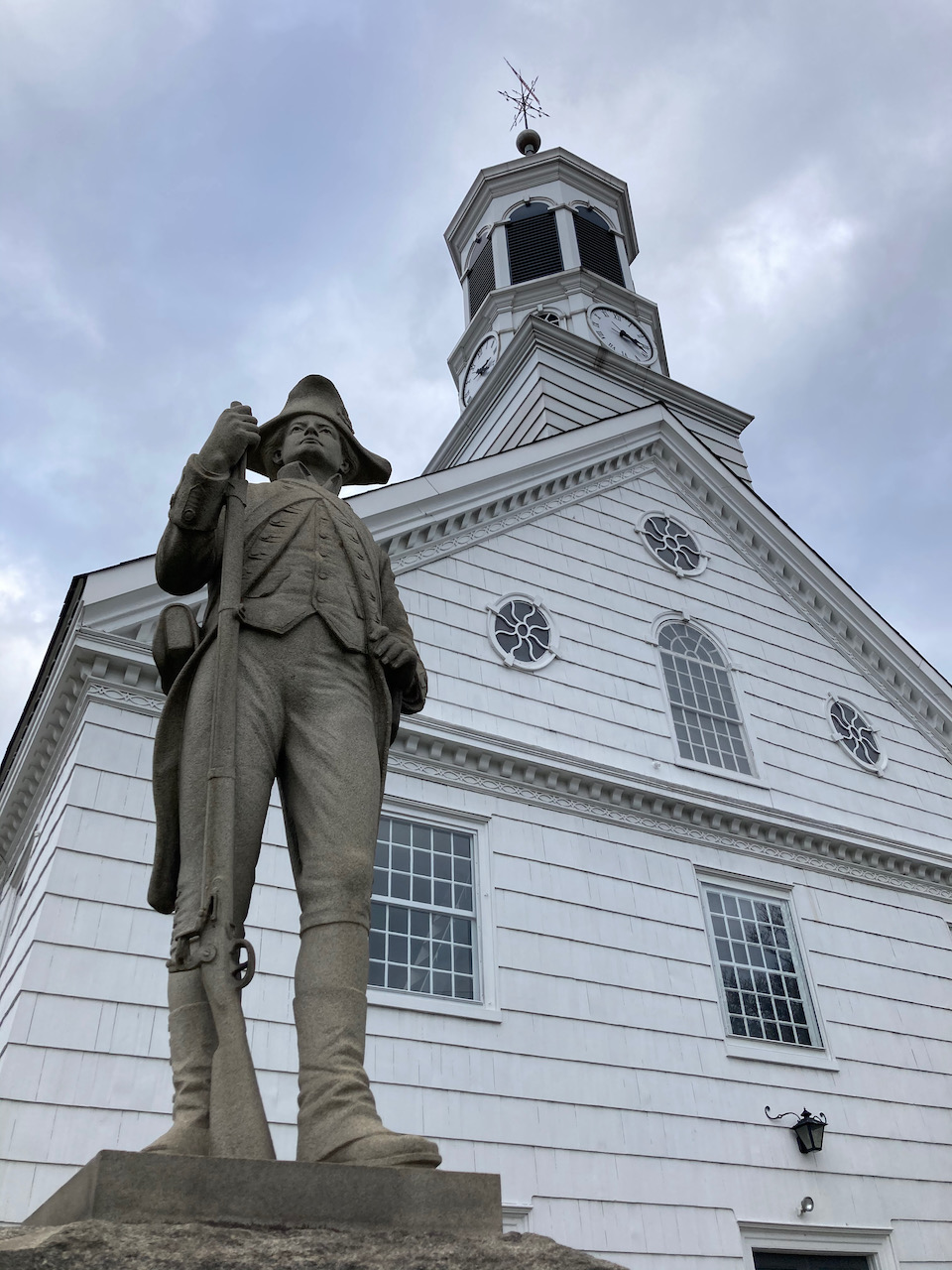Colonial soldier in front of church.