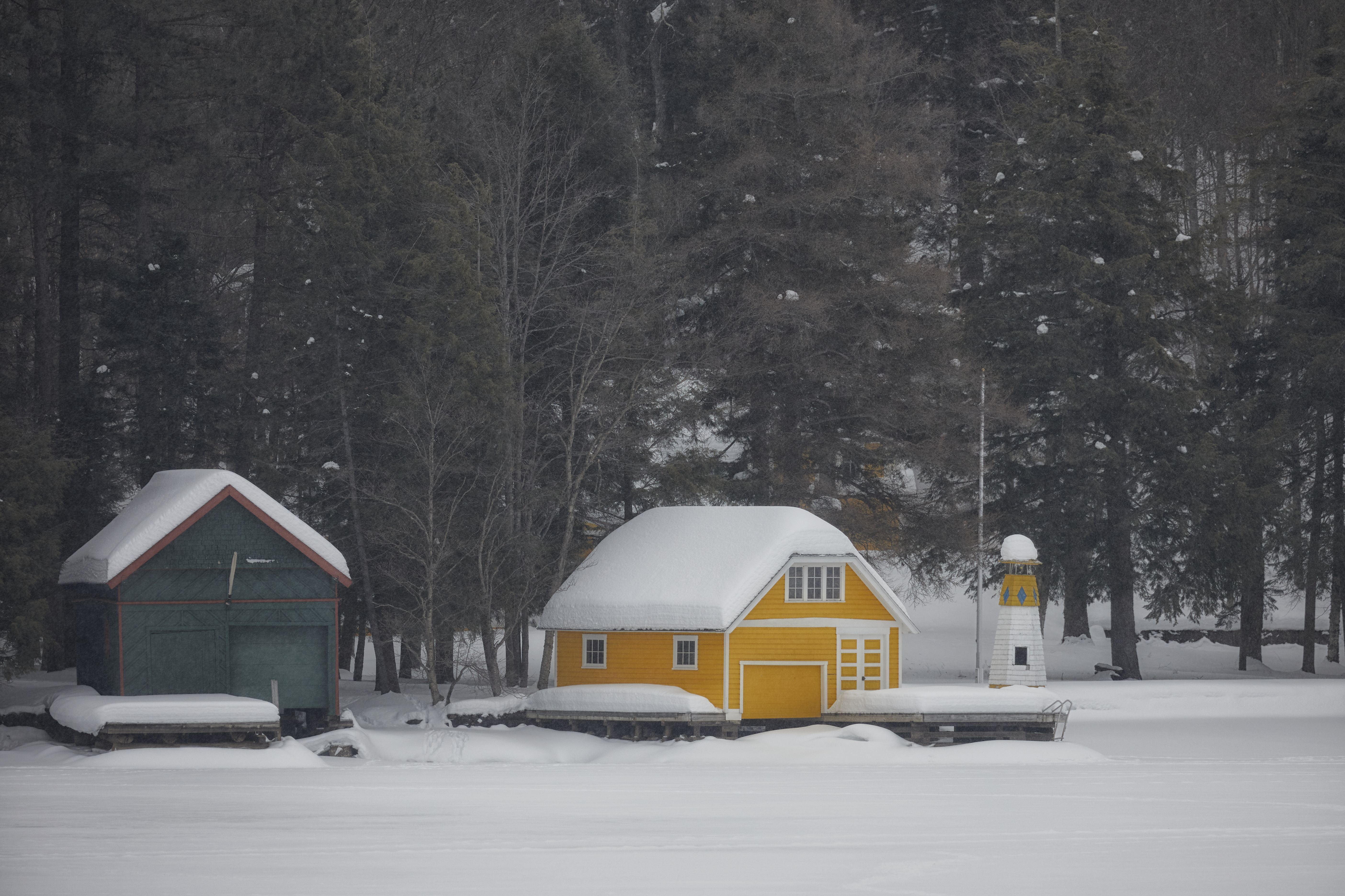 Two boathouses along shore of Old Forge Pond.