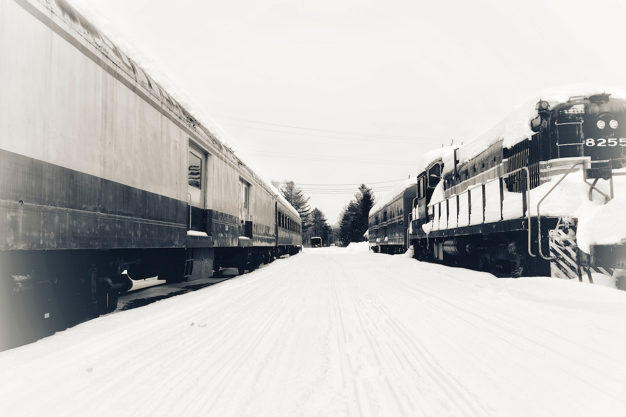 Trains on two parallel tracks in snow.