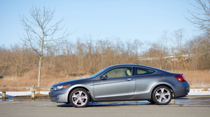 2012 Honda Accord coupe, parked beside wooded area.
