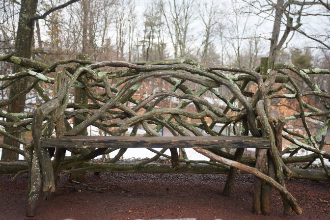 Wooden bench and fence made from tree branches.