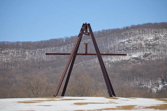 Four-legged pyramid structure in field.