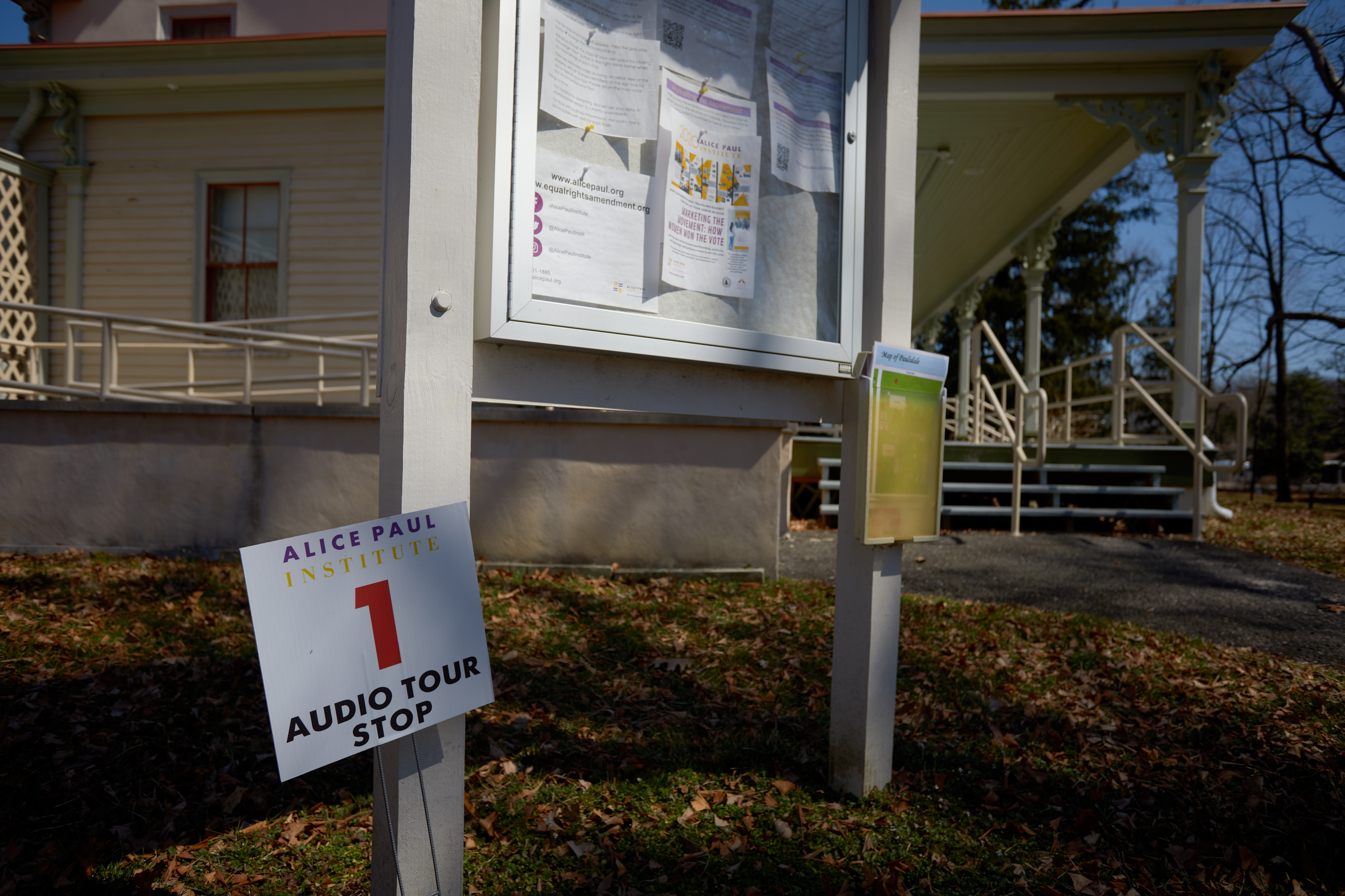 Signage outside Paulsdale mansion, with a small cardboard sign on lawn that says AUDIO TOUR STOP 1.