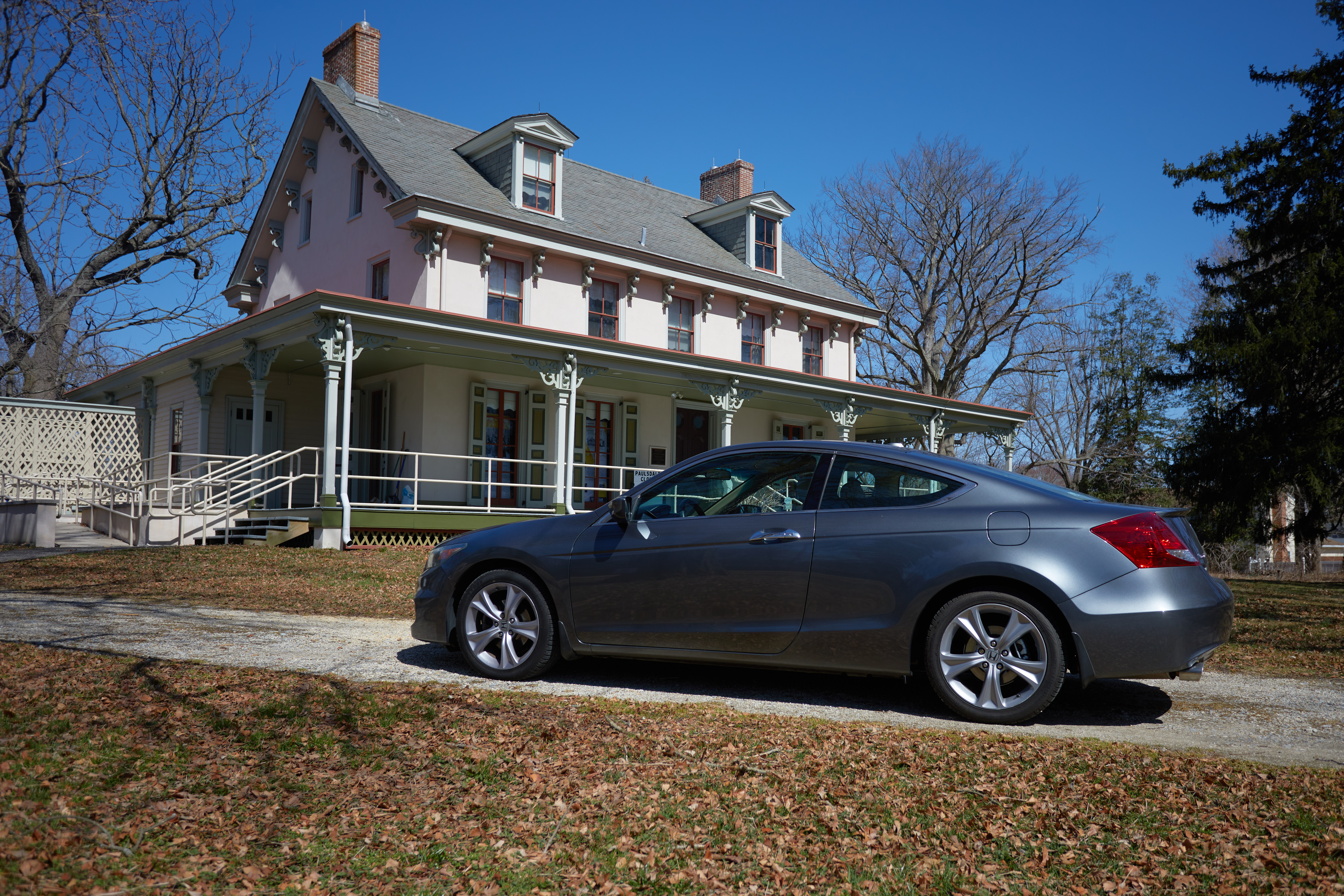 2012 Honda Accord parked in front of two-story mansion.