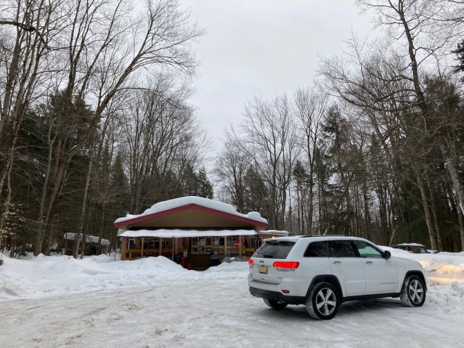 White Jeep Grand Cherokee parked in front of Eagle Bay Donut Shop.