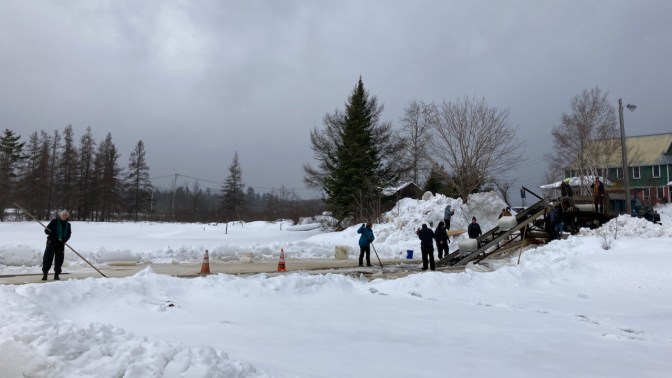 Ice cutting operation along shore of Raquette Lake.