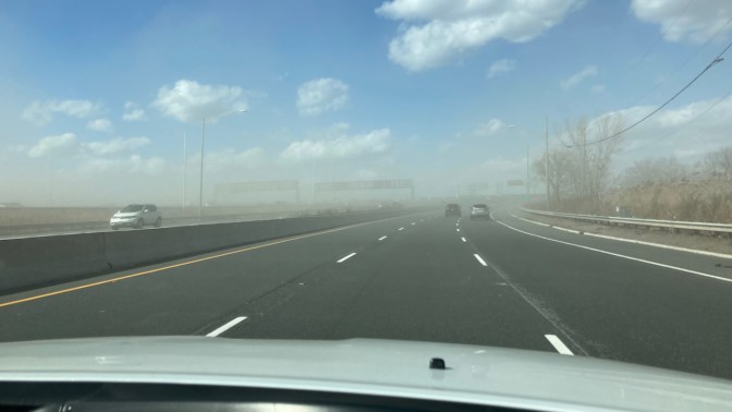 Sandstorm covering roadway.