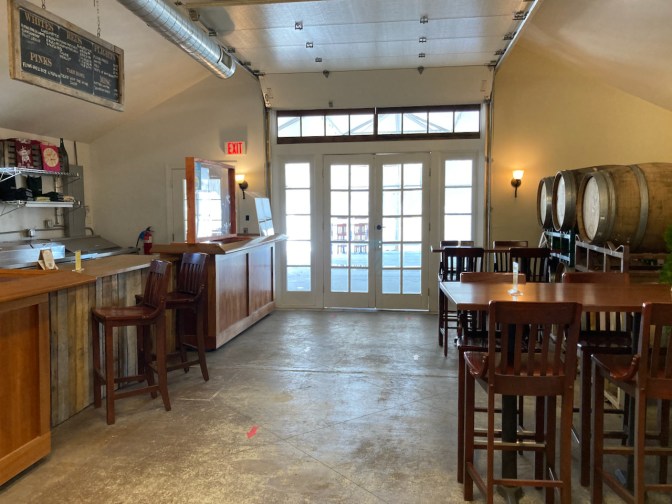 Interior of Hawk Haven Winery, showing tables and bar.