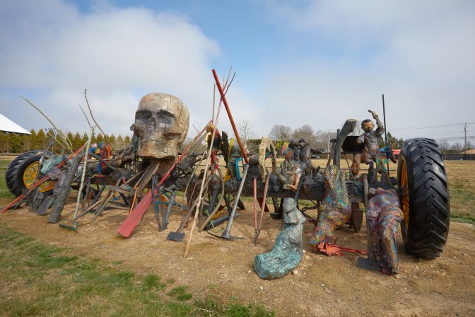 Old harvester with skull and sculptures on it. 