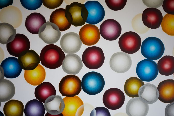 Painting of colored circles on canvas.