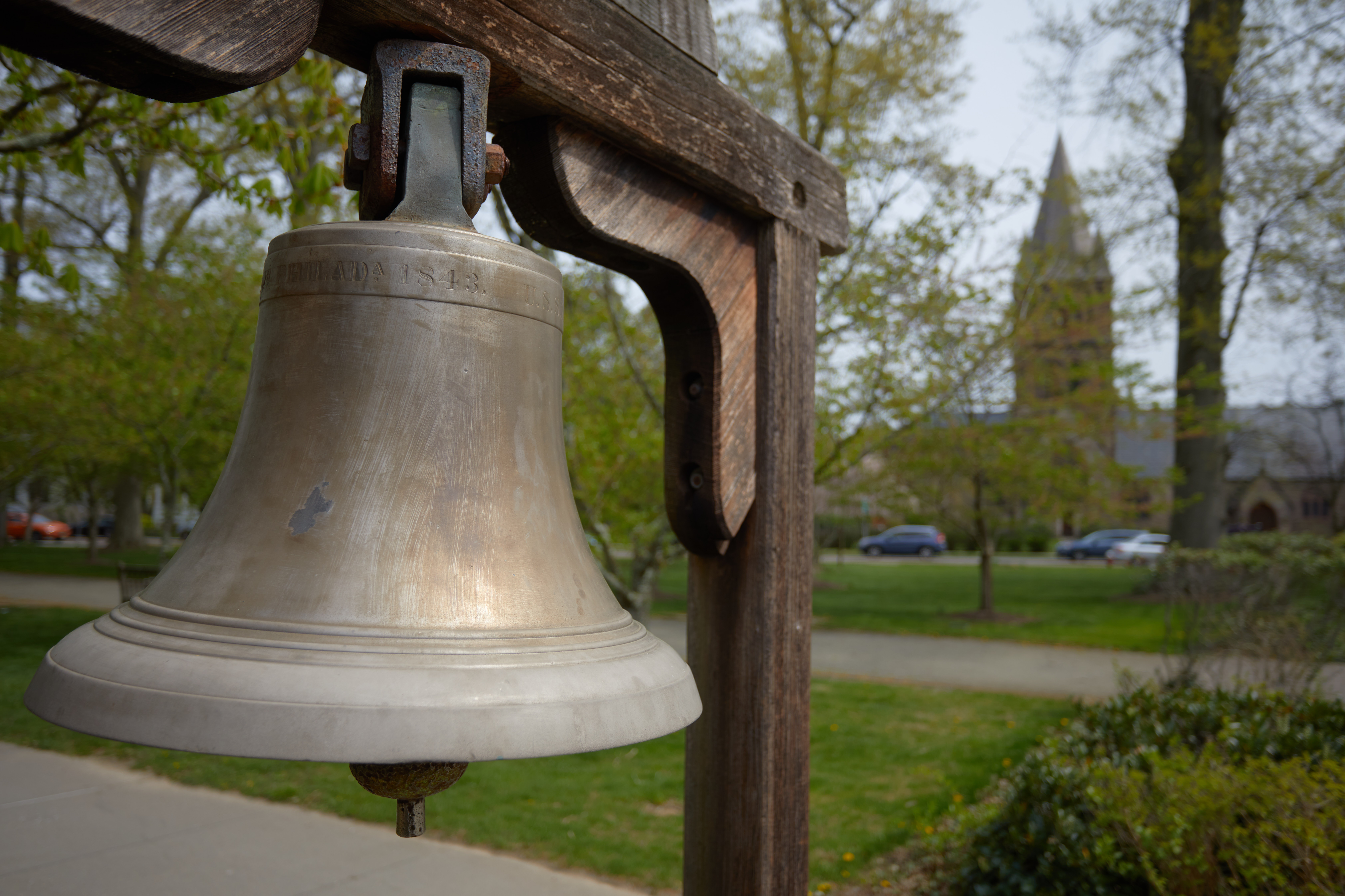 Bronze bell on wooden stand.