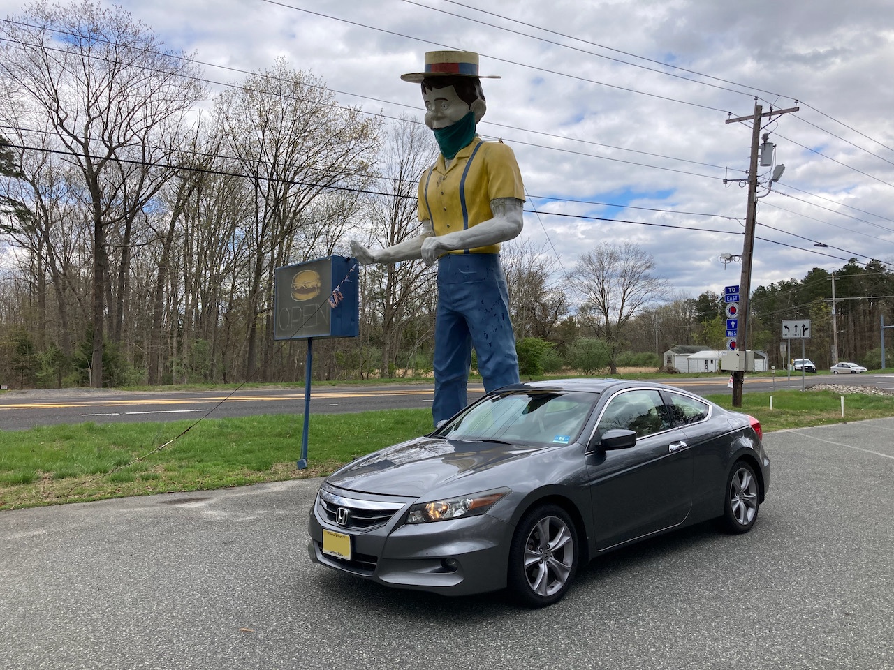 2012 Honda Accord parked in front of statue of man wearing hat and mask.