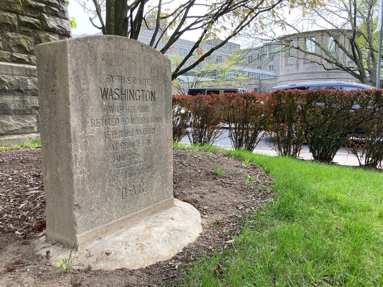 Stone marker beside building that says BY THIS ROUTE WASHINGTON WITH HIS ARMY RETIRED TO MORRISTOWN AFTER HIS VICTORY AT PRINCETON.