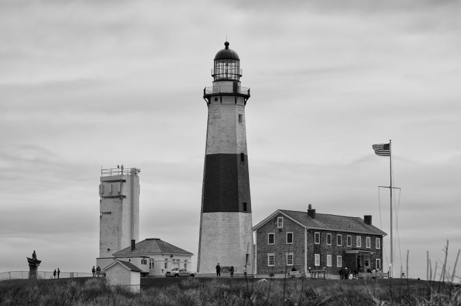 Black and white photo of Montauk Point light and associated buildings.