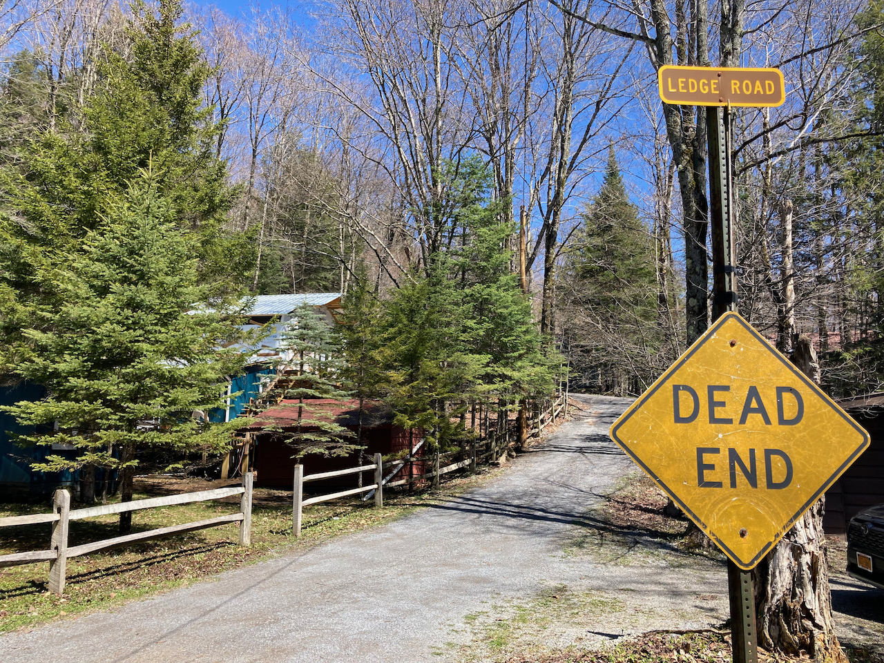 View of Ledge Road, with a sign in foreground that says DEAD END.