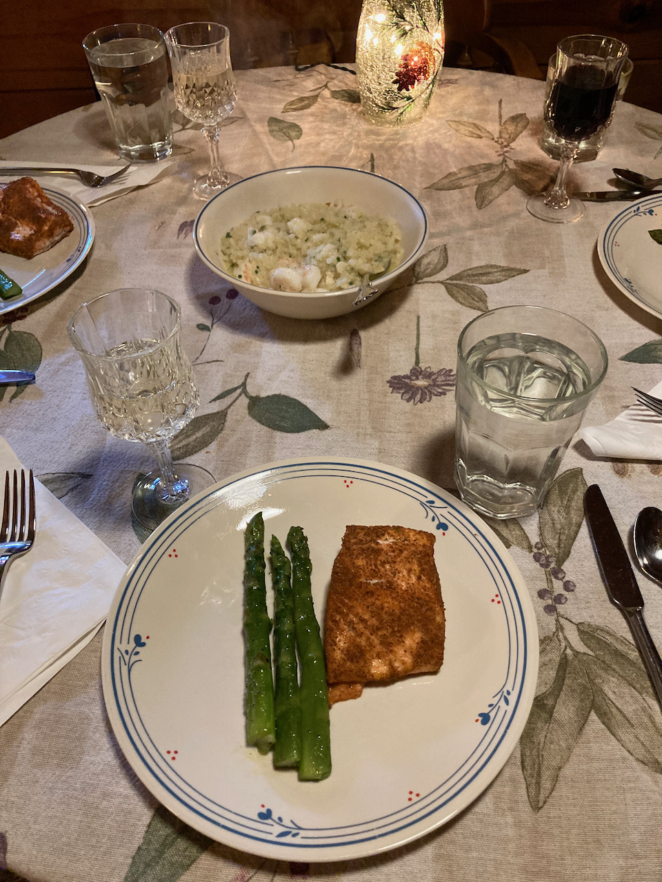 Plates of asparagus, salmon, and seafood risotto.