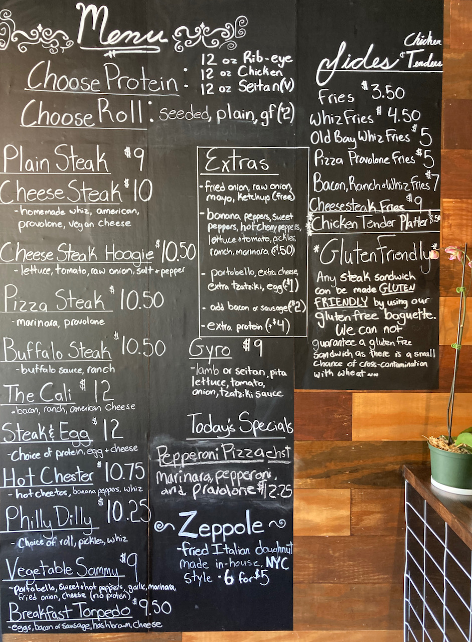 Blackboard menu in restaurant listing all options.