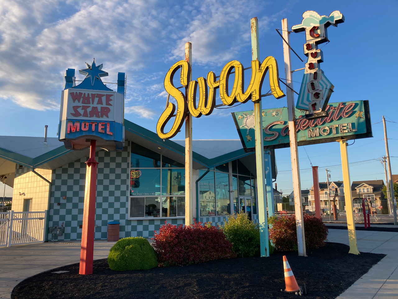 Exterior of Doo Wop Museum, with several 1950s signs.