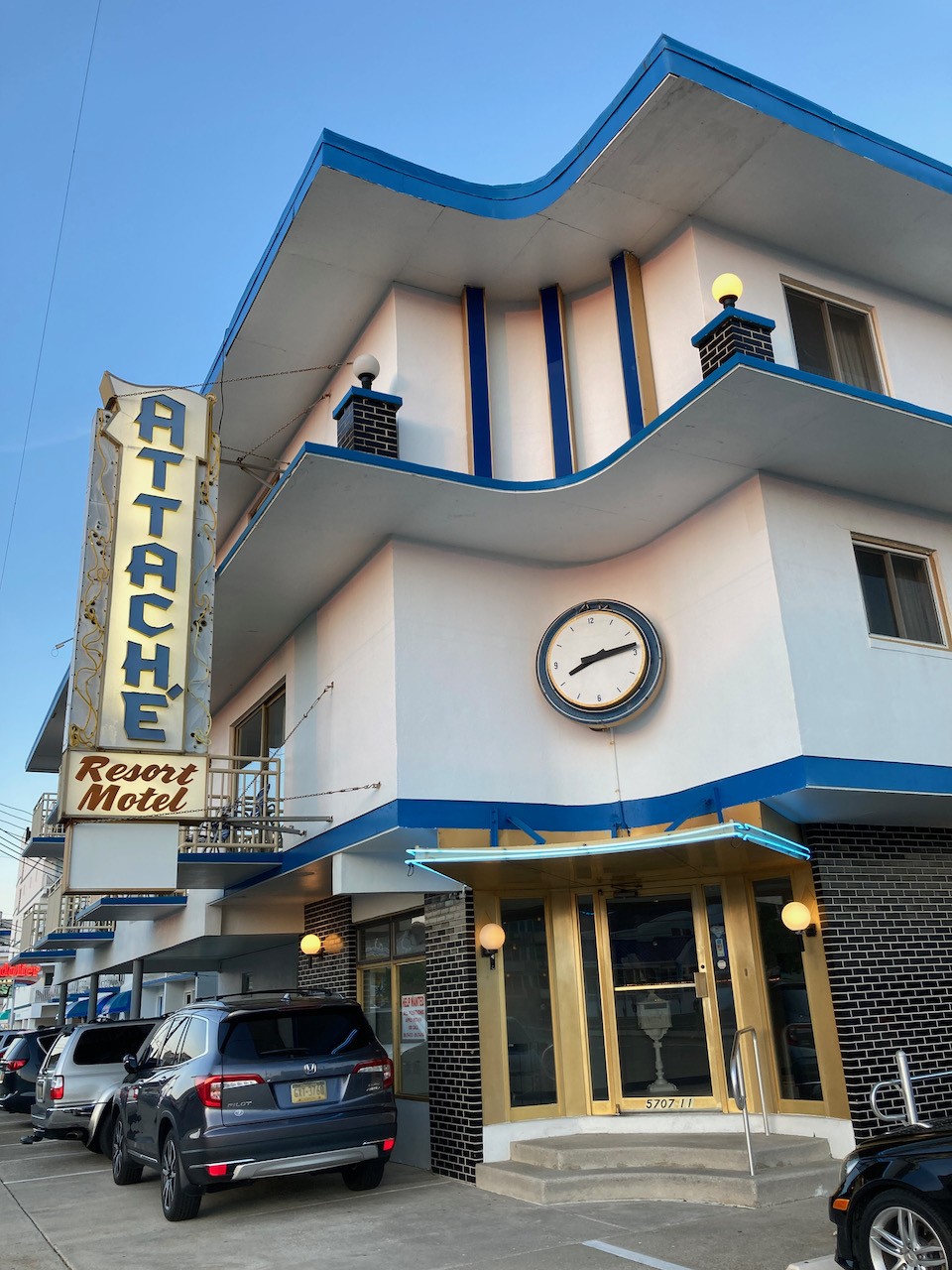Exterior of Attache Hotel, with neon sign for Attache.