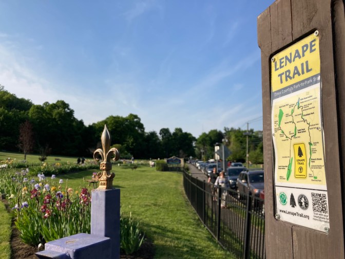 Sign beside garden that has map of Lenape Trail.