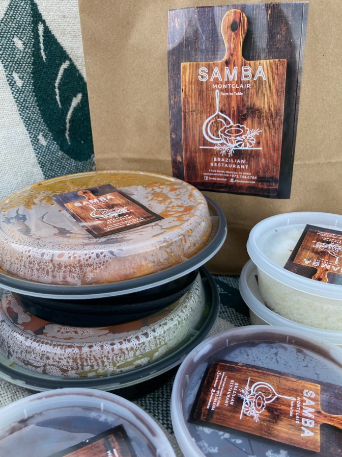 Take-out bag from Samba restaurant, along with several plastic containers of food.