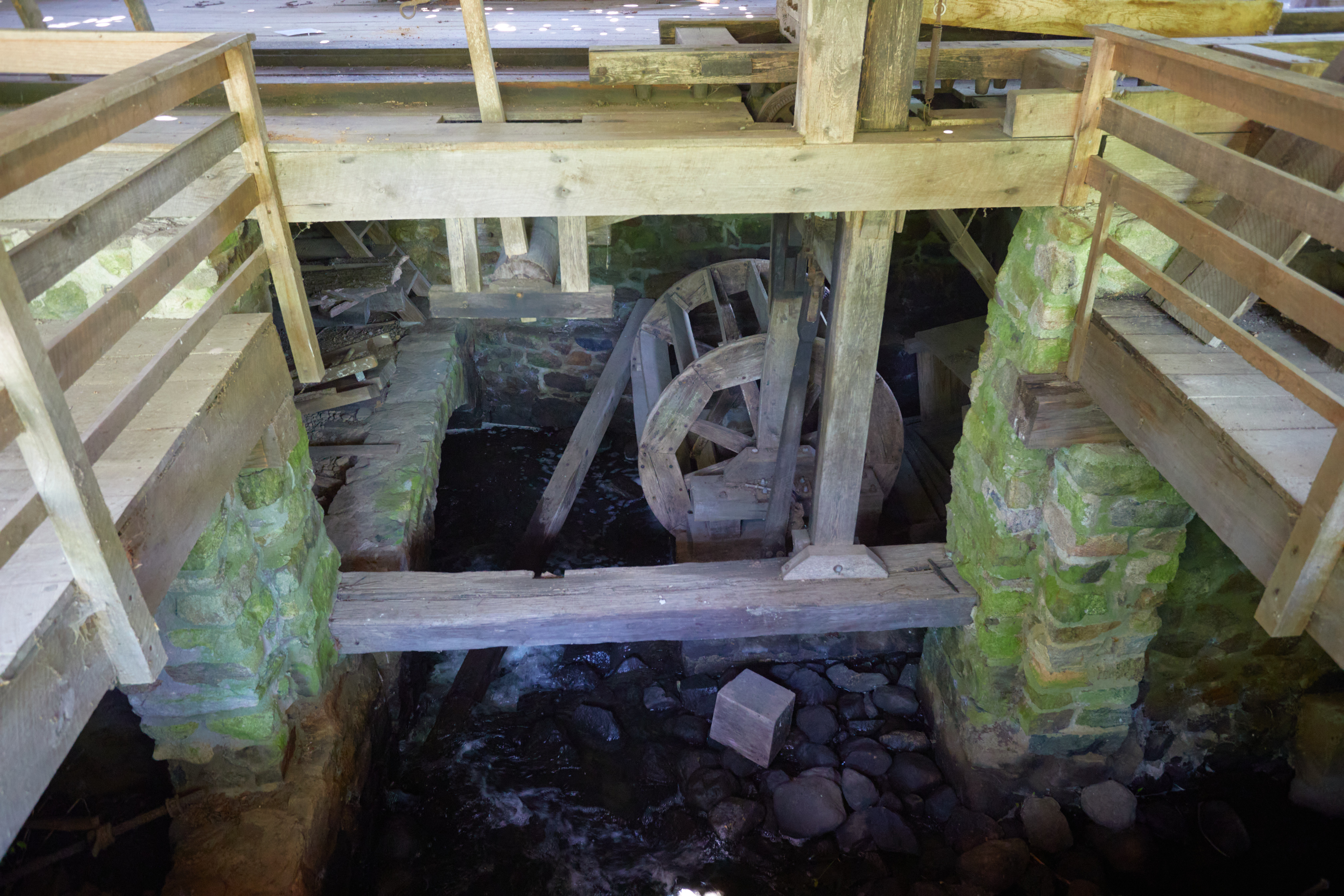 View of water wheel beneath gristmill.