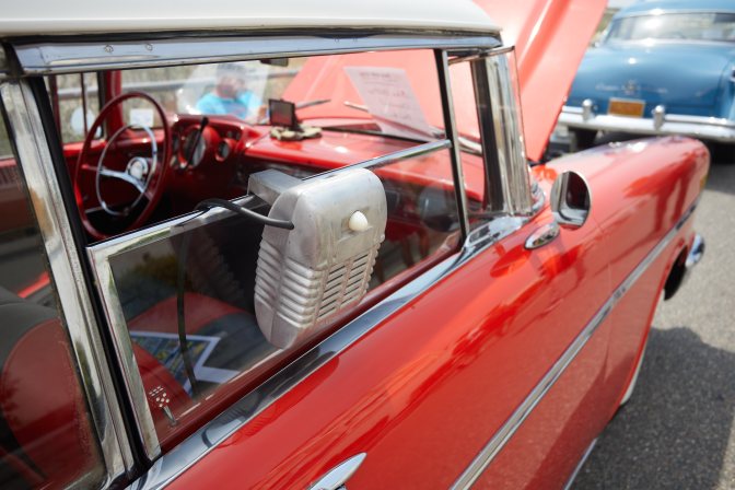 Small metal speaker on window of Chevrolet Bel-Air.
