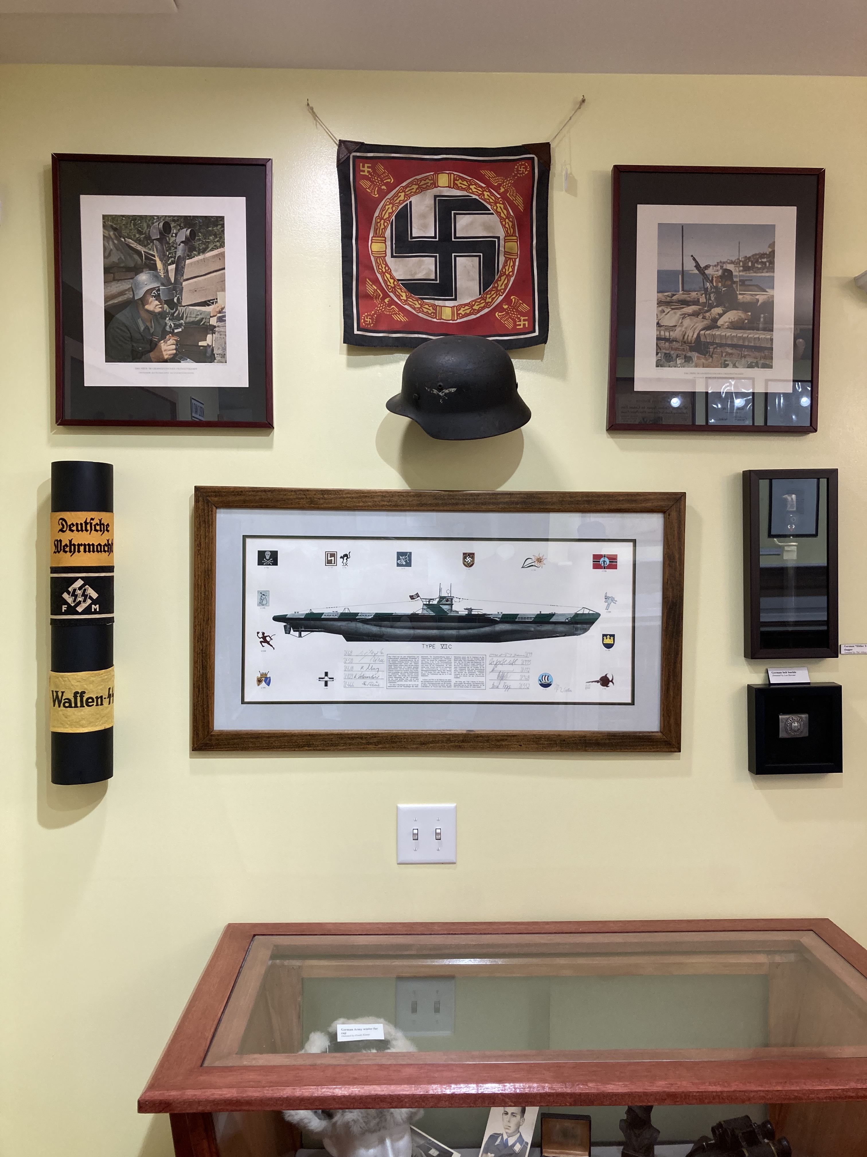 Display of Nazi items on wall and in case.