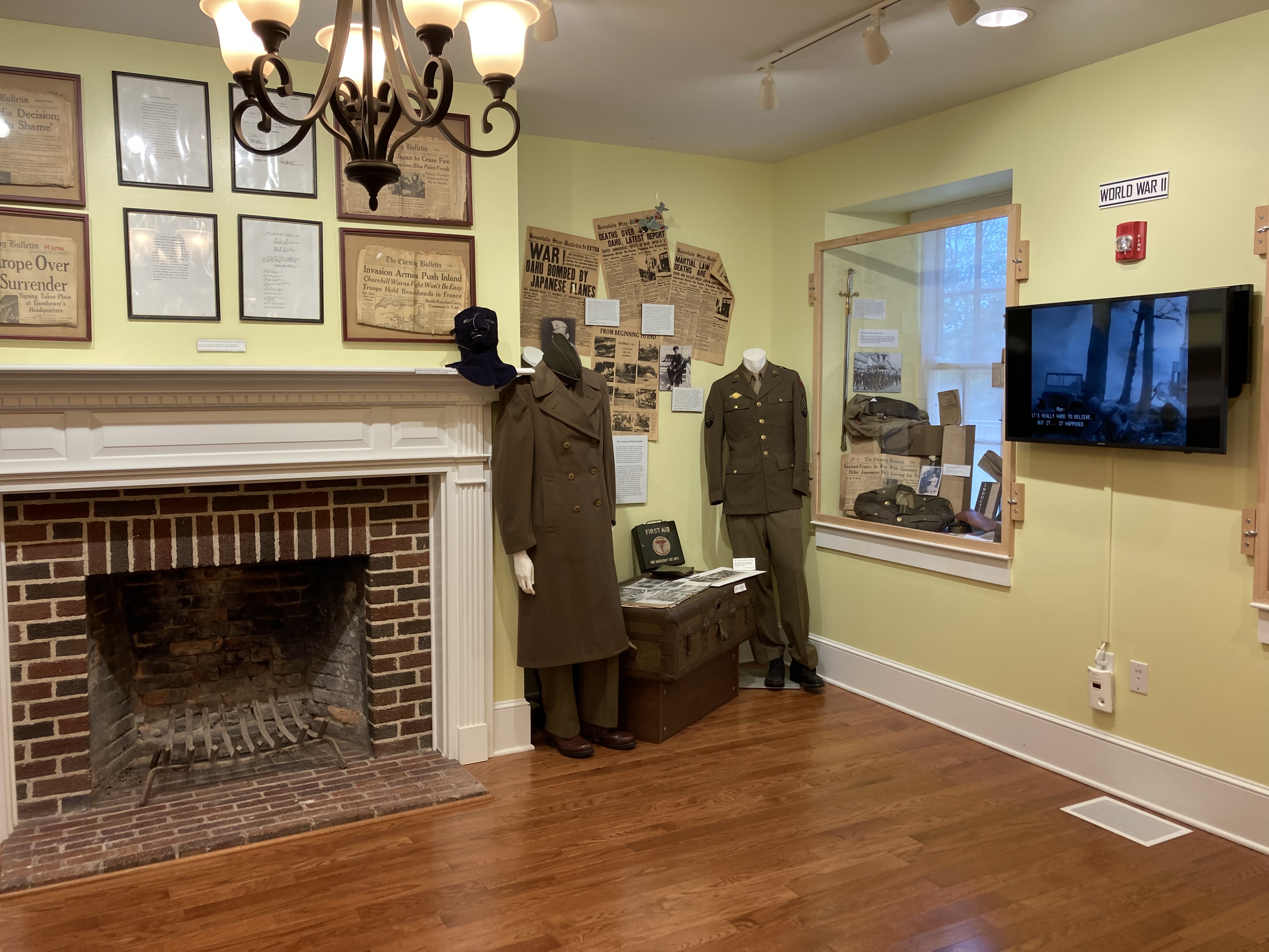 Exhibit on World War II, including uniforms and newspaper clippings.